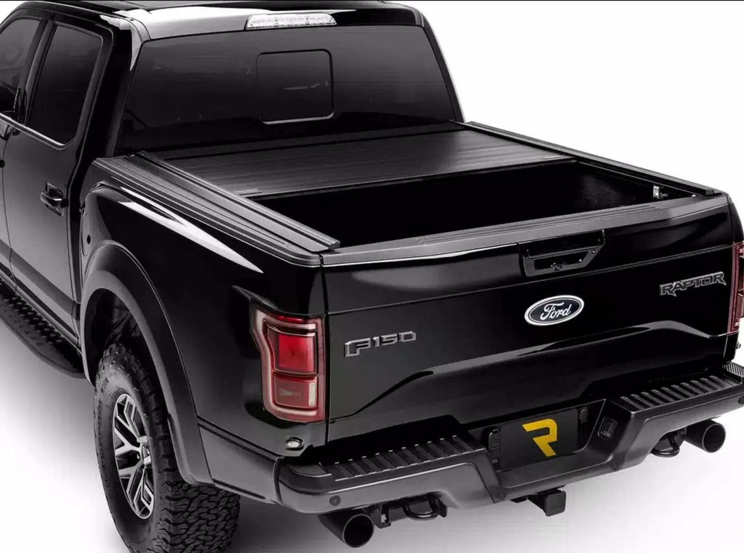 A black Ford F-150 with a low-profile retractable tonneau cover sitting flush with the bed rails