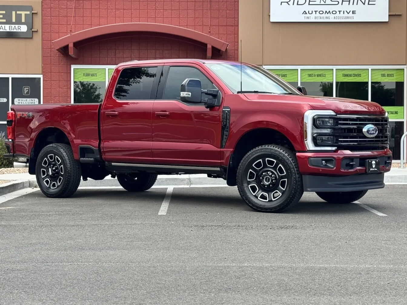 A red Ford F-250 Super Duty parked outside the Ride N' Shine storefront