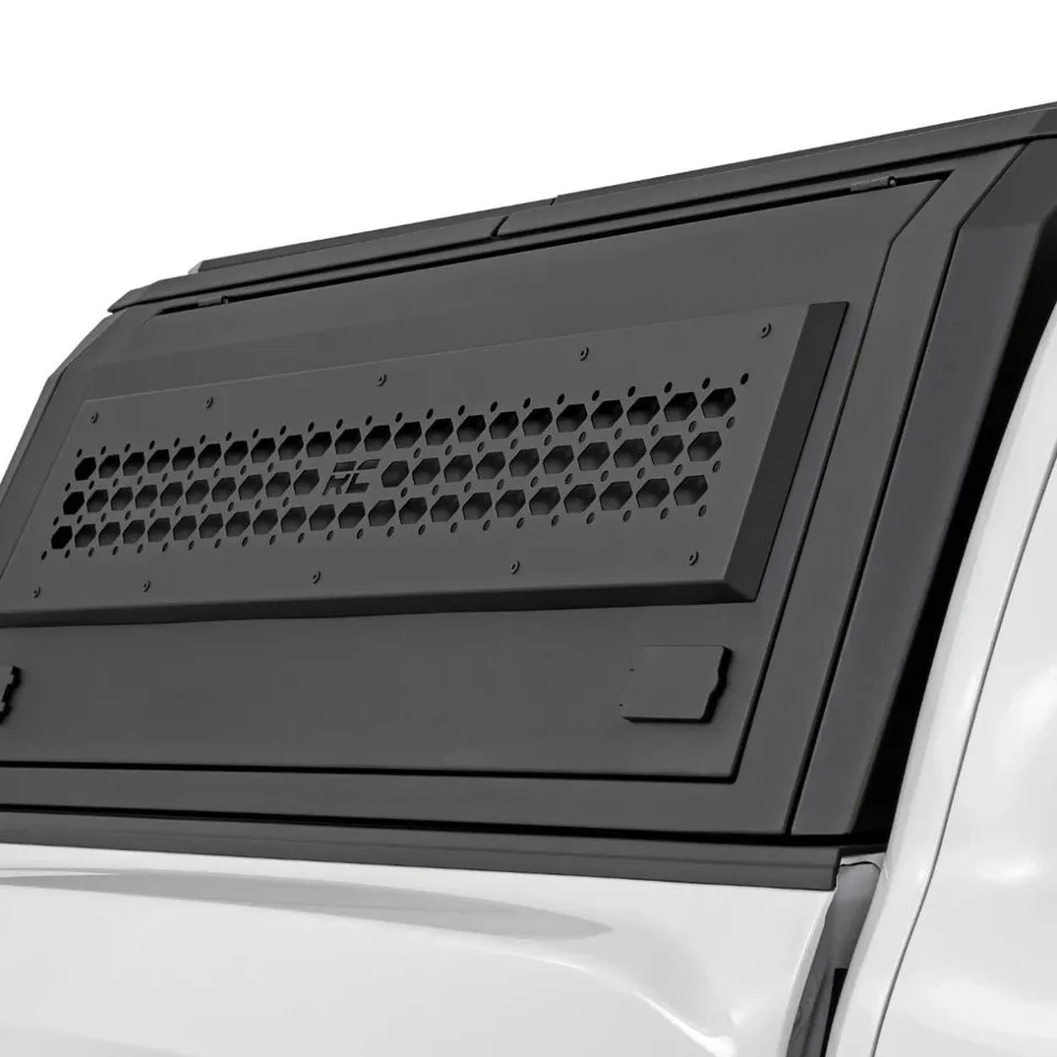 Closeup of a truck bed cap’s vented side panel and matte aluminum construction