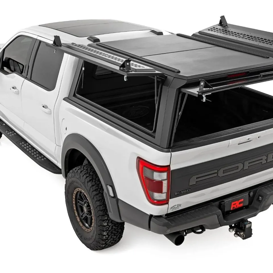 Ford F-150 with a low-profile aluminum truck bed cap installed, seen from the rear three-quarter angle